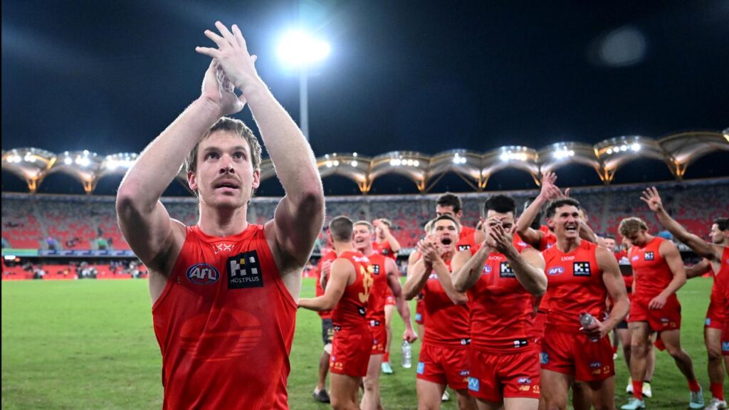 Suns captain Noah Anderson leads off his victorious team after the win over Collingwood.