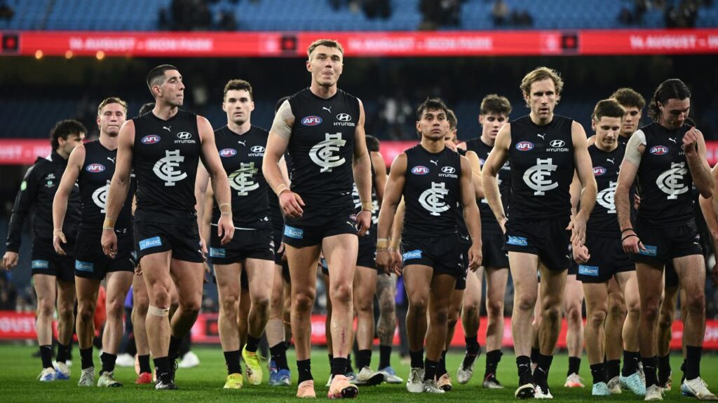 Patrick Cripps leads his Carlton teammates from the field as pressure mounts on coach Michael Voss.