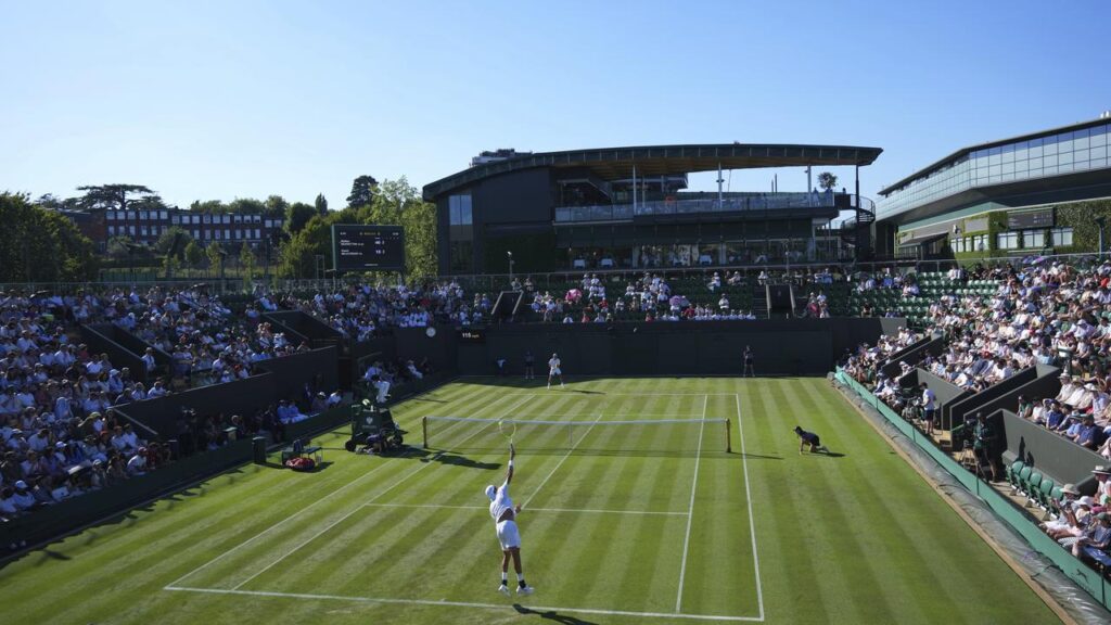 Matteo Berrettini serves under a cloudless sky as temperatures reach 32.3C at Wimbledon.
