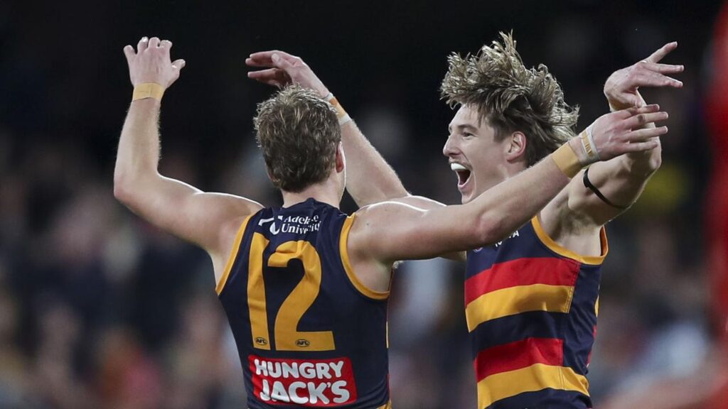 High-flying Crows: Jordan Dawson and Josh Worrell celebrate a goal in the thrasing of Gold Coast.
