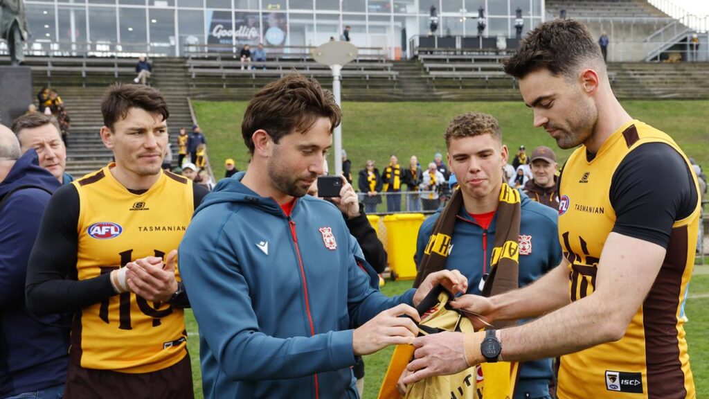 Conor Nash presented a guernsey at Tuesday’s training to visiting Wrexham player Aaron James.