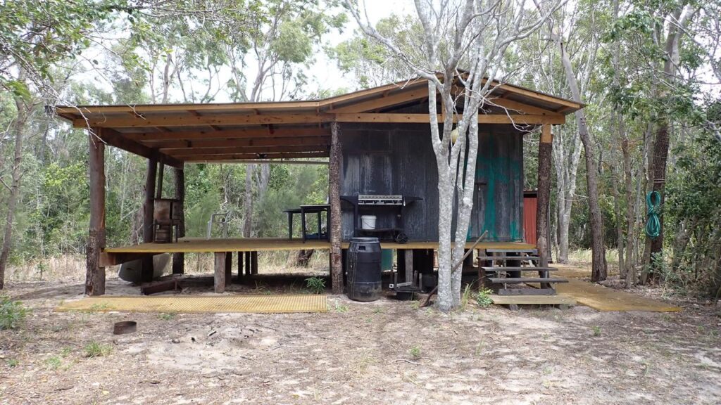 A group had cleared trees in an island national park and used them to make a hut, authorities say.
