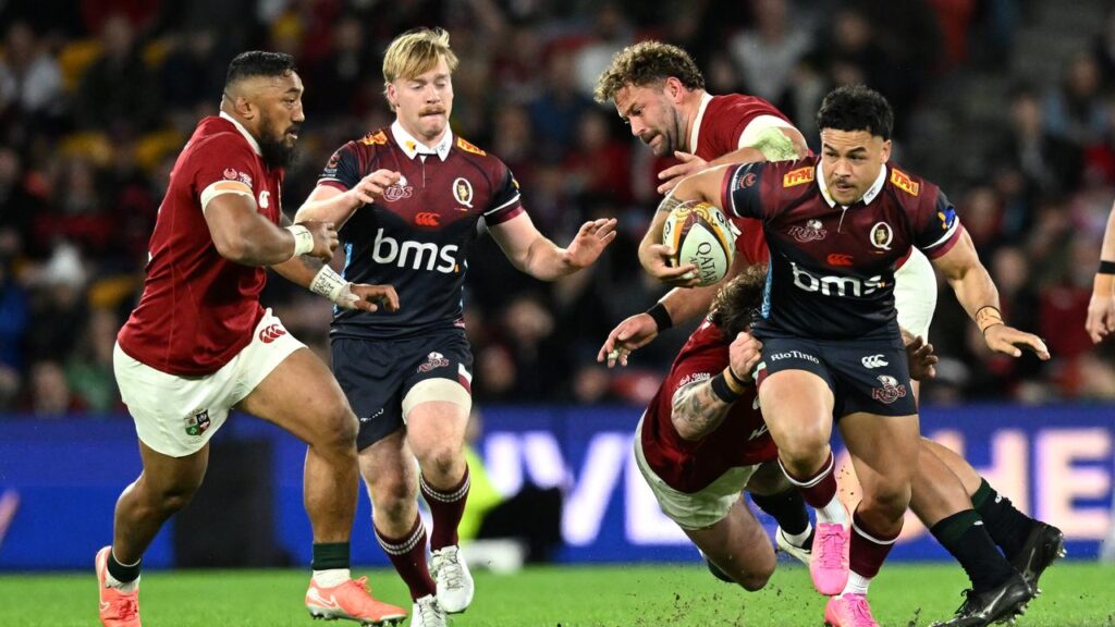 Hunter Paisami (r) makes a break for the Reds in their clash against the British & Irish Lions.
