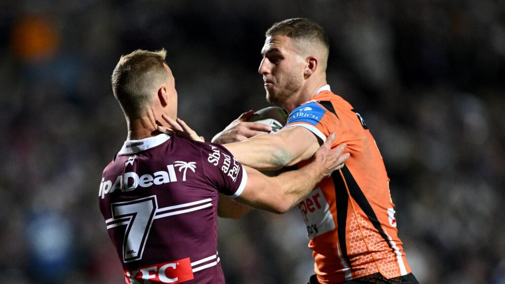 Adam Doueihi (r) is back in the halves for Wests Tigers in a reshuffled line-up.
