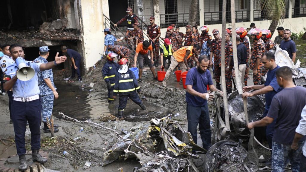A jet appeared to have rammed into the side of a Dhaka building, creating a hole in the structure.