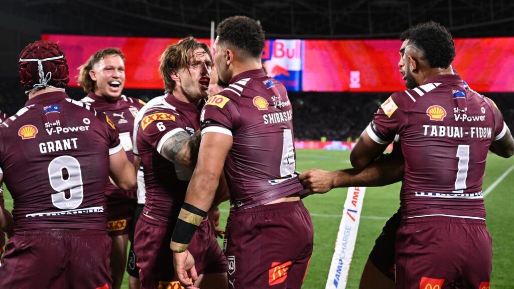 Cameron Munster (c) fires up his Maroons who were too strong for NSW.