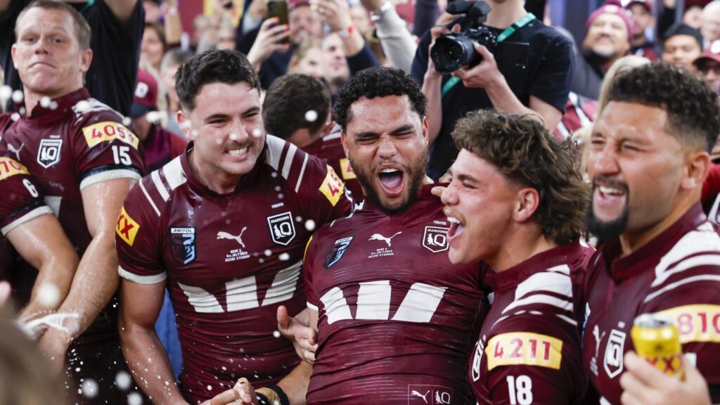 The victorious Maroons sing the team song in the rooms after their Origin triumph.