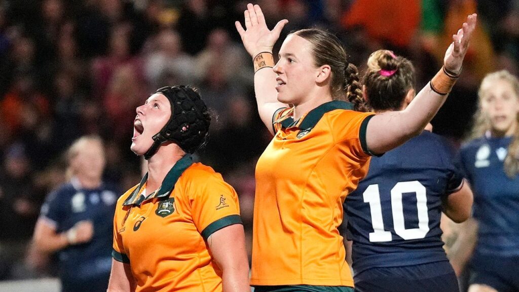 Caitlyn Halse, arms outstretched, celebrates a try in the World Cup draw against the US.