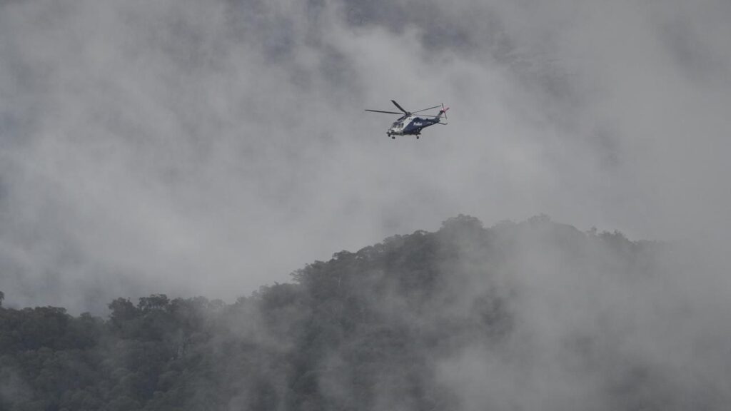 Harsh weather in Victoria’s alpine region is complicating the hunt for an accused cop killer.