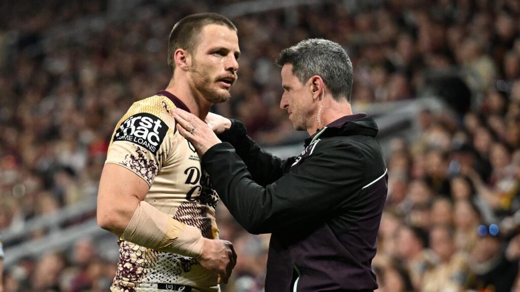 Brisbane forward Jack Gosiewski (L) gets attention for what turned out to be a fractured collarbone.
