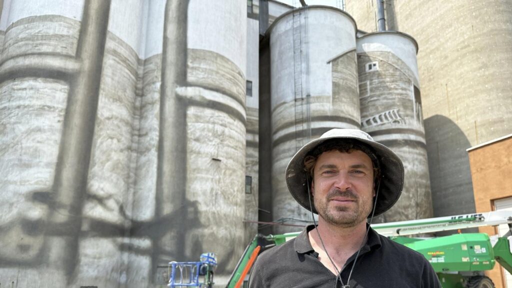 Guido van Helten is transforming a grain silo in a North Dakota town into a larger-than-life mural.
