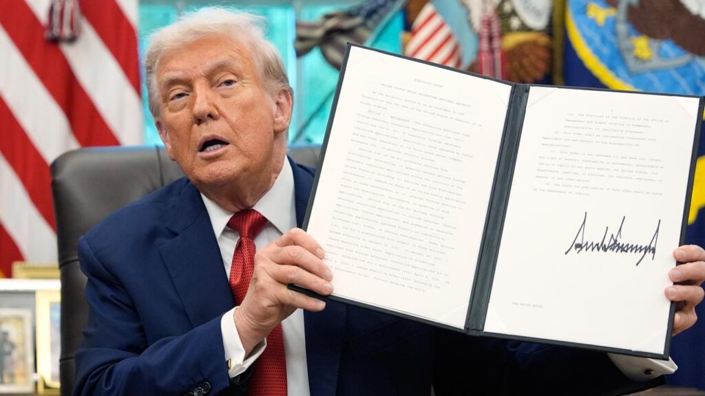 President Donald Trump holds a signed executive order for TikTok’s transfer to US owners.
