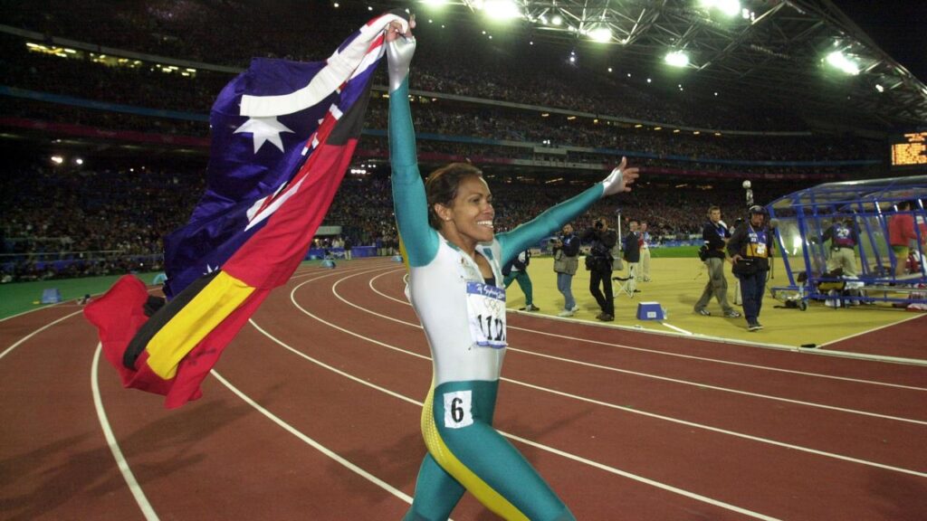 AAP photographer Dean Lewins was permitted to shadow Cathy Freeman on her famous victory lap.