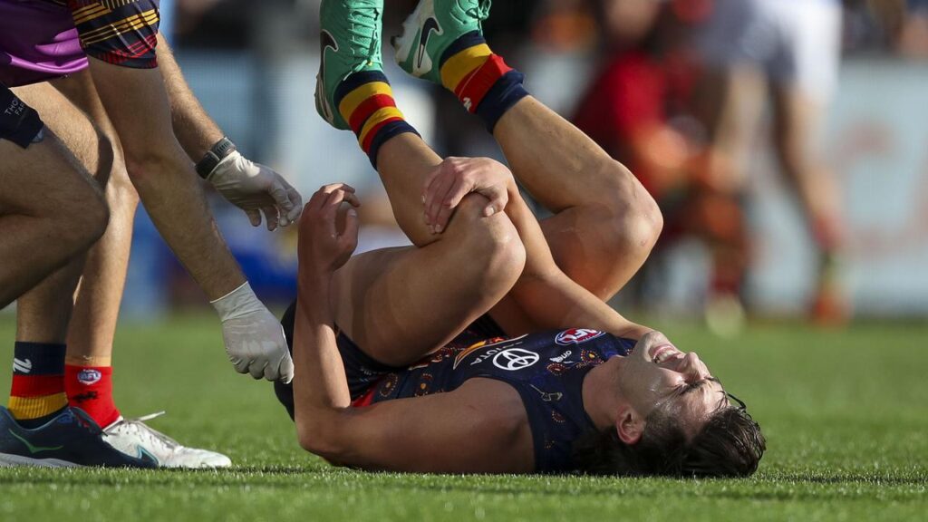 Josh Rachele, here suffering his injury against the Demons in July, could be back for the Crows.