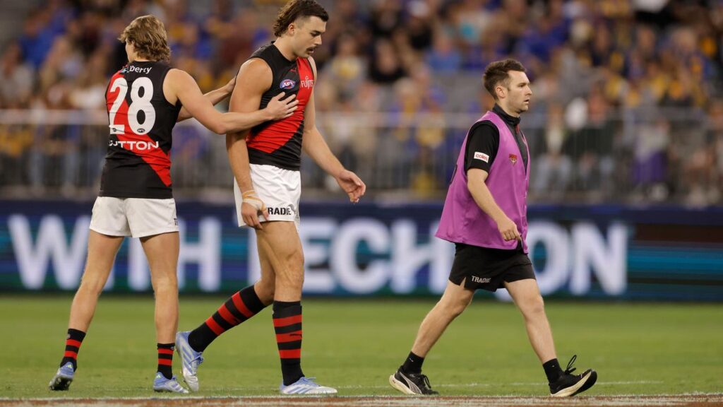 Essendon ruck Sam Draper exits the field in round six after suffering a season-ending injury.
