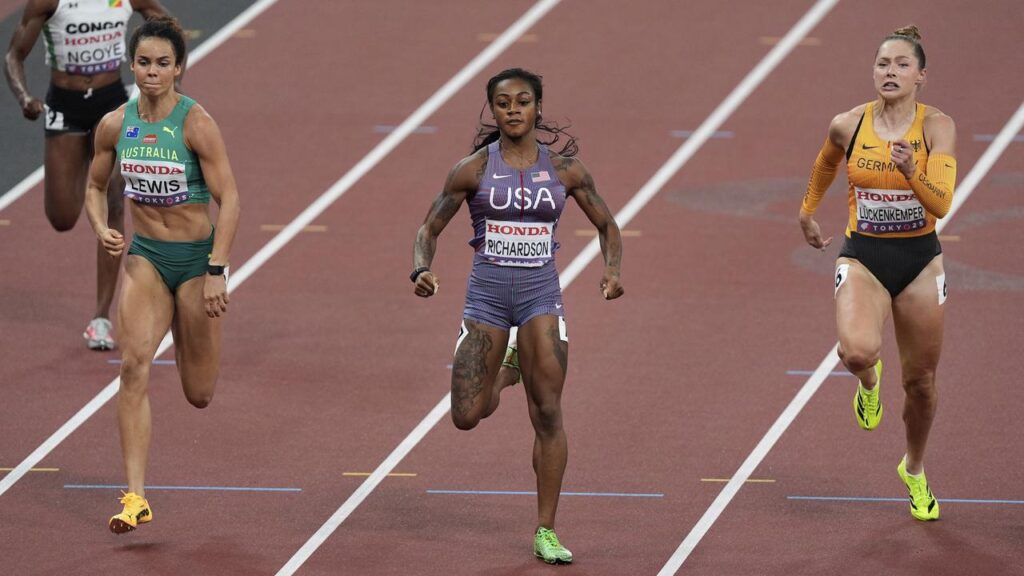 Torrie Lewis flies home to finish third in her 100m heat at the world championships. 
