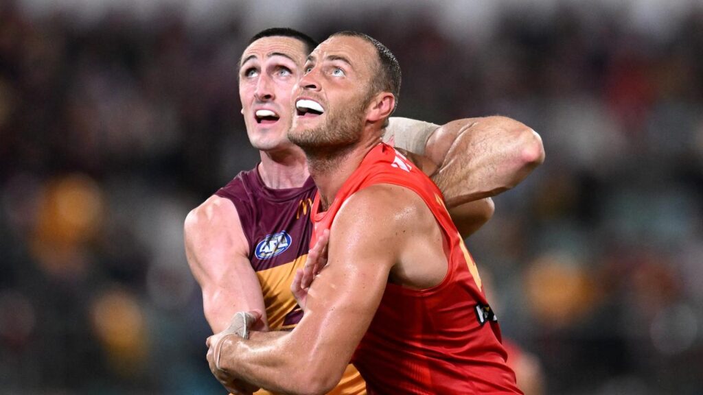 The recalled Oscar McInerney (left) will have his hands full with Suns ruckman Jarrod Witts.
