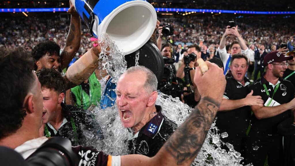 Broncos coach Michael Maguire getting doused after their fantastic grand final triumph.
