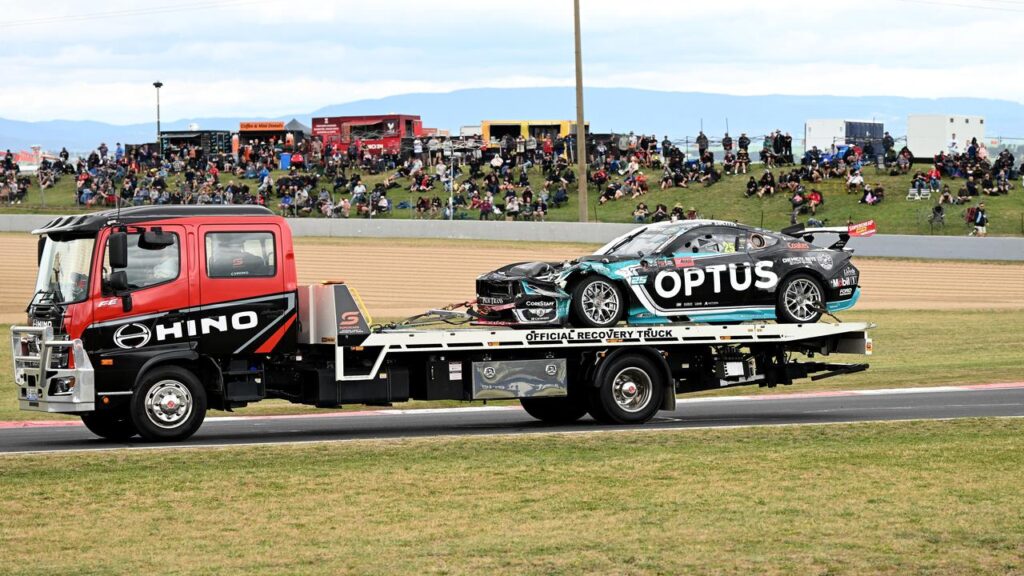 The damaged Walkinshaw Andretti United Ford Mustang of Chaz Mostert is towed away after his crash.
