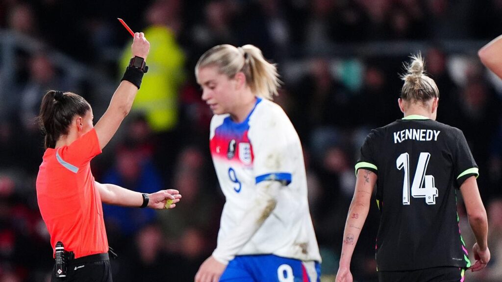 Alanna Kennedy walks off after being shown a red card for fouling England’s Alessia Russo (centre).