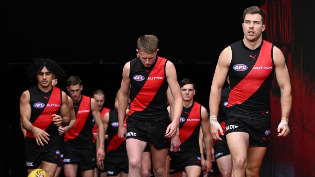 Essendon captain Zach Merrett (right) is in trade limbo as he tries to join Hawthorn.
