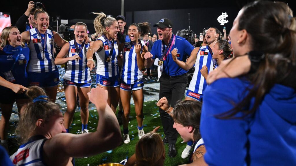 Coach Darren Crocker enjoys the Kangaroos’ grand final triumph with his players.
