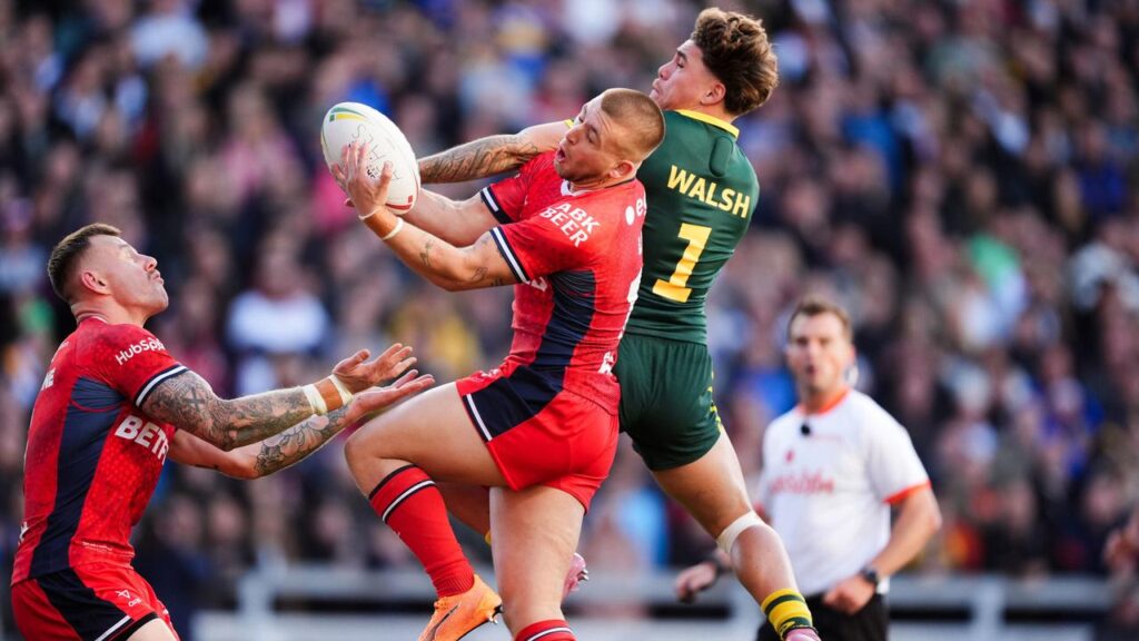 Reece Walsh challenges Mikey Lewis for the ball in the Kangaroos’ third Test win. 
