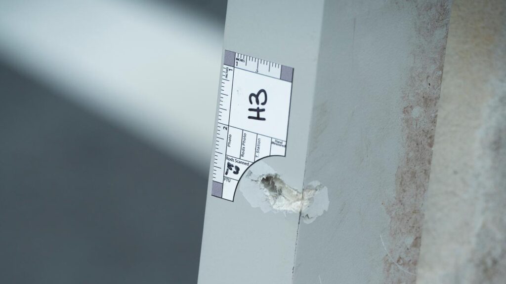 Investigators have marked bullet holes after a man shot two National Guard soldiers.
