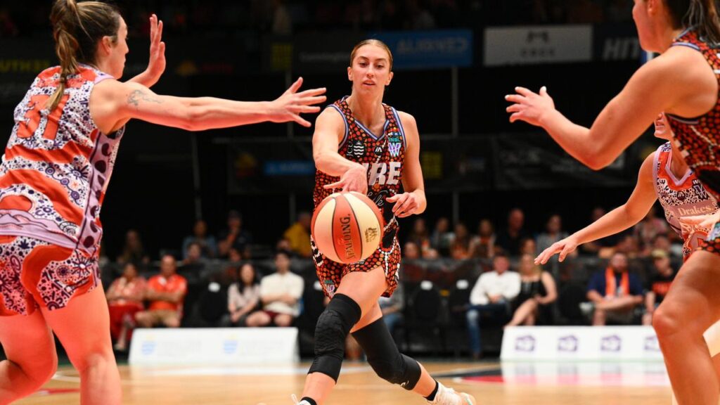 Lucy Olsen fires a pass for WNBL leaders Townsville Fire in their big win over Adelaide Lightning.
