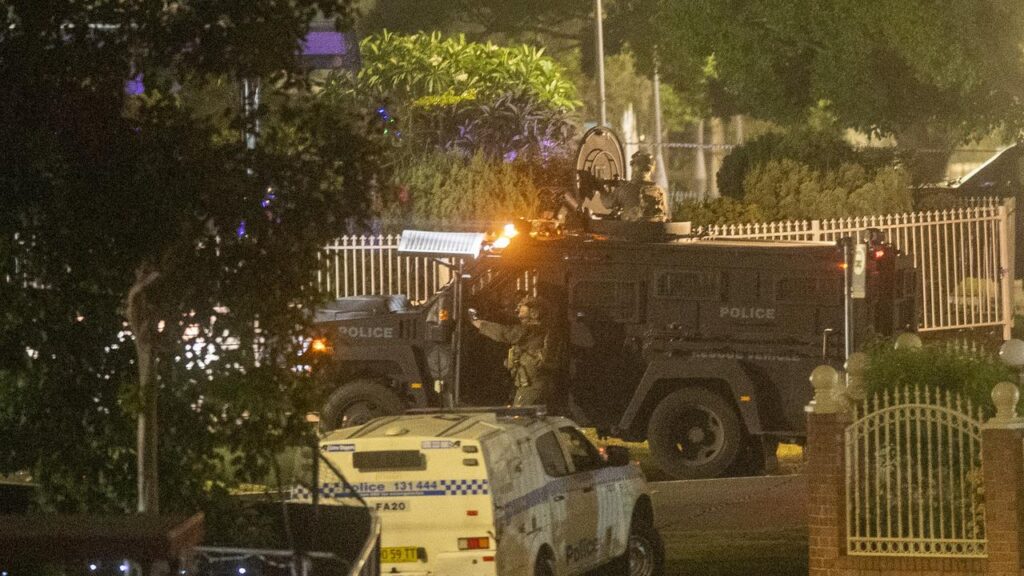 Police raided a house in southwestern Sydney linked to one of the suspected gunmen.
