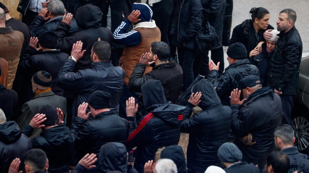 Hundreds of mourners have gathered outside a Homs mosque that was attacked killing eight.
