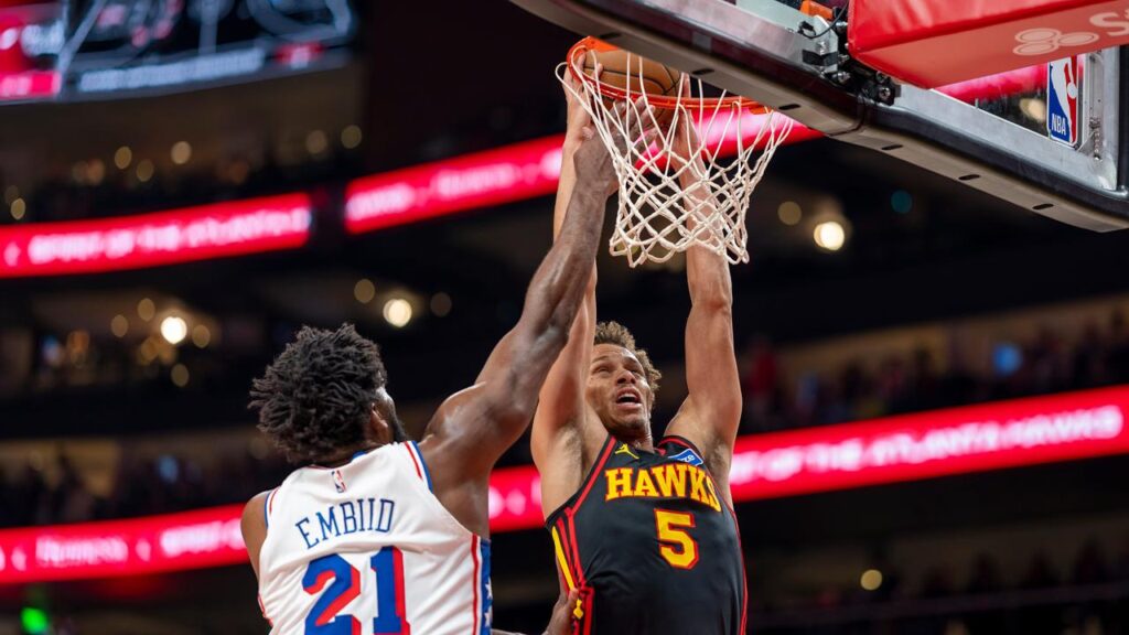 Atlanta’s high-flying Dyson Daniels slams it home despite attention from the 76ers’ Joel Embiid.
