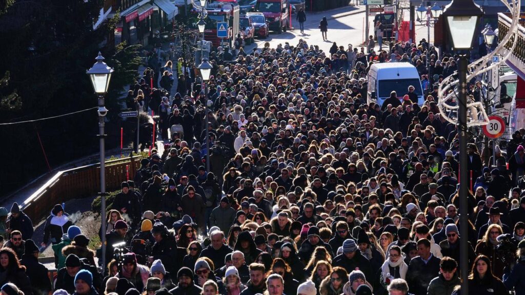 Hundreds have marched in silence after a church service to honour the victims of a bar fire.
