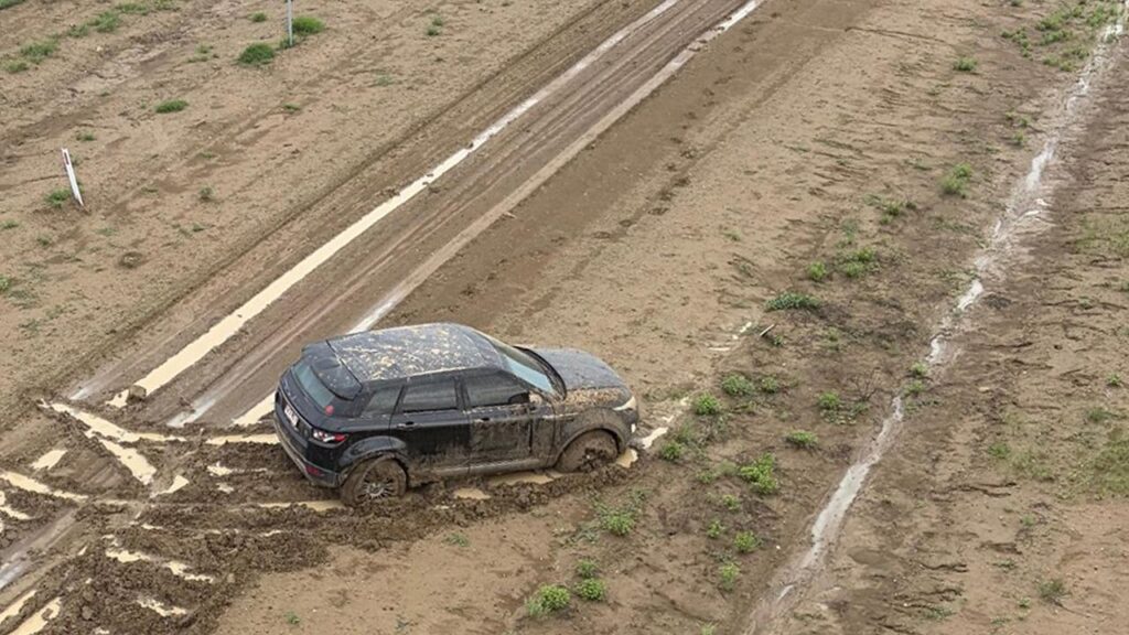 A trail of footprints in the mud near a bogged car was all the rescue crew had to go on.
