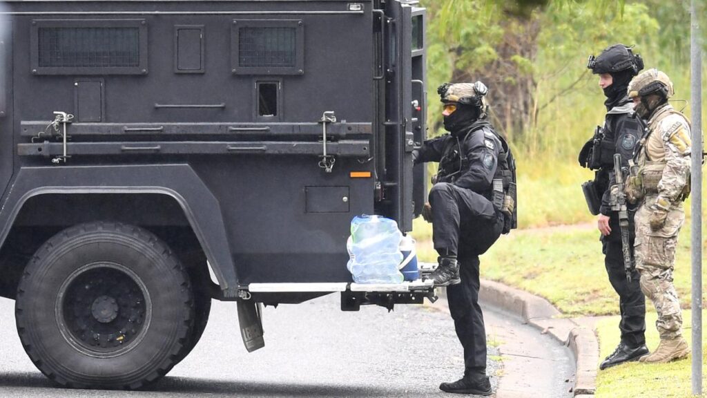 A woman accused of being involved in a five-hour siege with heavily armed police has been bailed.
