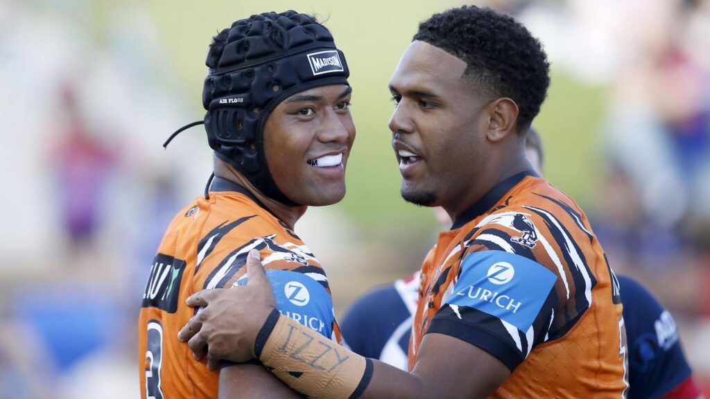 Wests Tigers’ Heamasi Makasini (l) celebrates one of his three tries against the Sydney Roosters.
