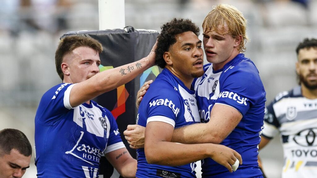 Justin Matamua (c) celebrates scoring a try with his new Bulldogs teammates.
