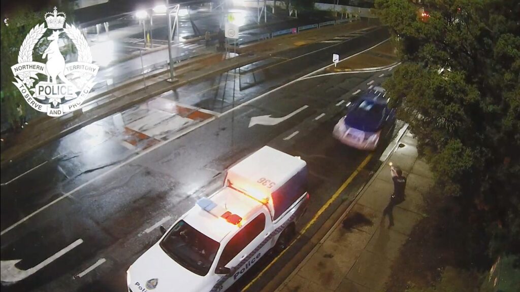 A man was arrested after allegedly ramming a police car while trying to run down officers.
