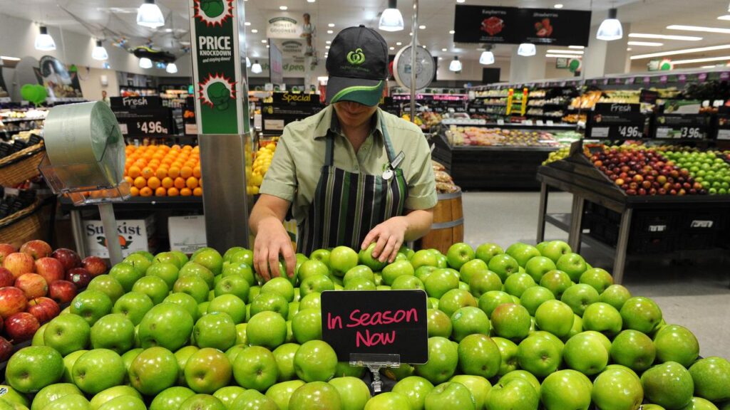 First-half profit for Woolworths has been cut in half following a back pay court ruling.
