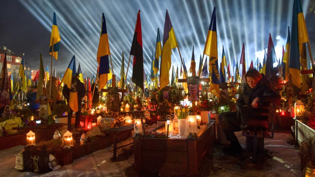 Lights shine over soldiers’ graves as Ukraine marks the fourth anniversary of Russia’s invasion.

