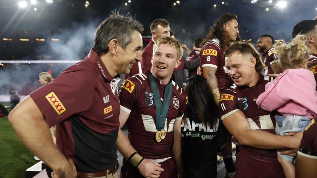 Maroons coach Billy Slater (l) celebrates the 2025 Origin series win with his players.
