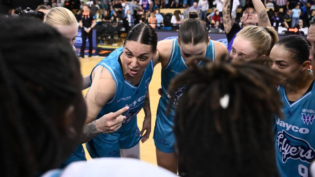 Cayla George (c) fires up the Flyers after beating the Townsville Fire to force a deciding game.
