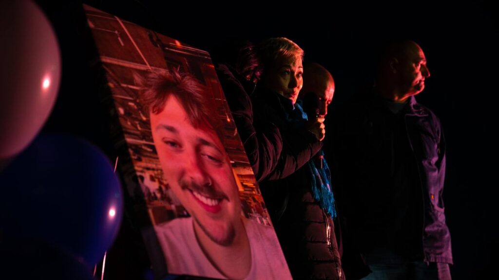 Aidan Becker’s family spoke at a candlelight vigil for the slain off-duty security guard.
