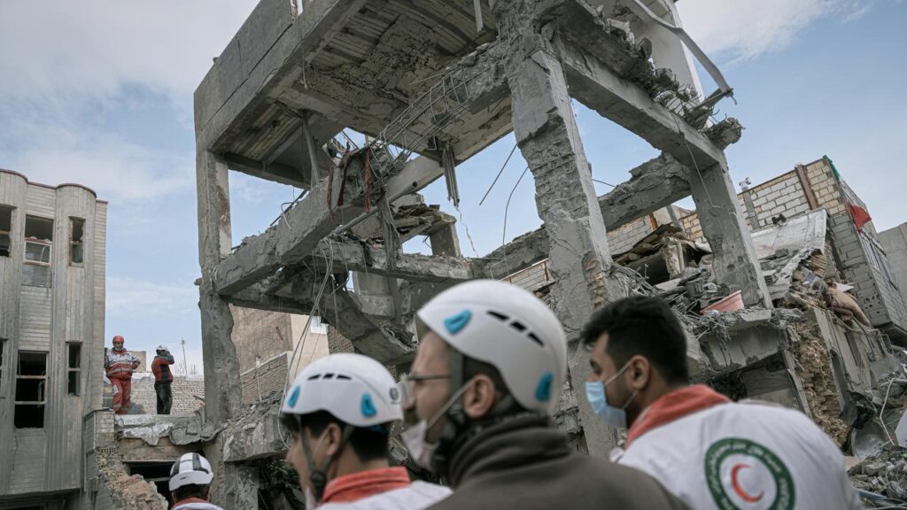 First responders inspect a residential building hit in an overnight strike in Tabriz, Iran.
