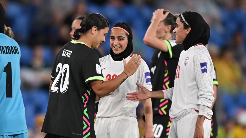 Sam Kerr salutes Iran opponents Sara Didar and Golnoosh Khosravi after Australia’s Asian Cup match.

