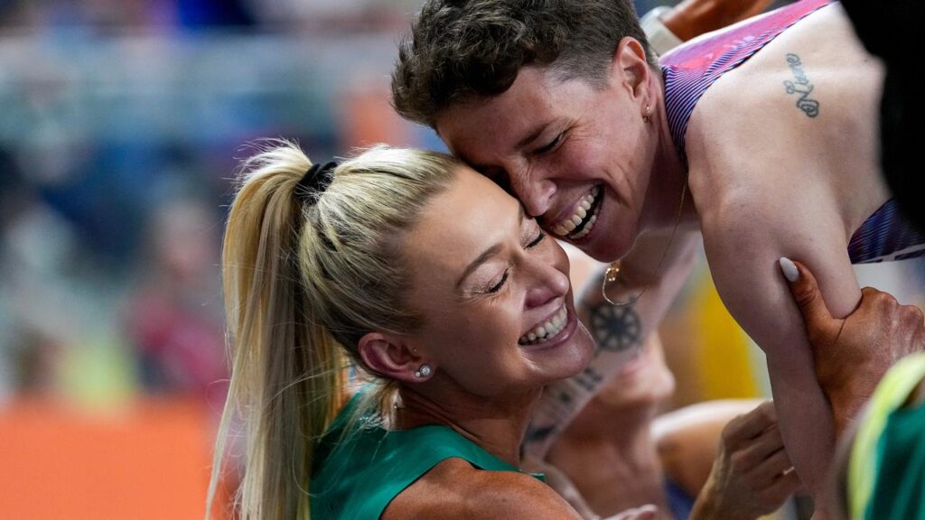 Australian Jess Hull (L) hugs 1500m bronze medallist Nikki Hiltz after winning world indoor silver.
