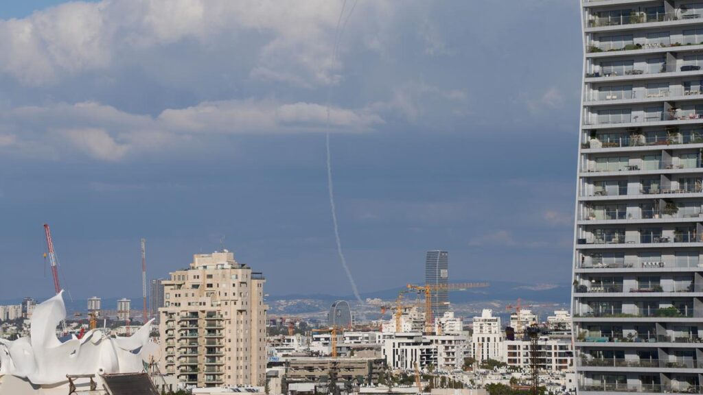 Israel faces retaliatory attacks from Iran, with traces of an air defence visible over Tel Aviv.
