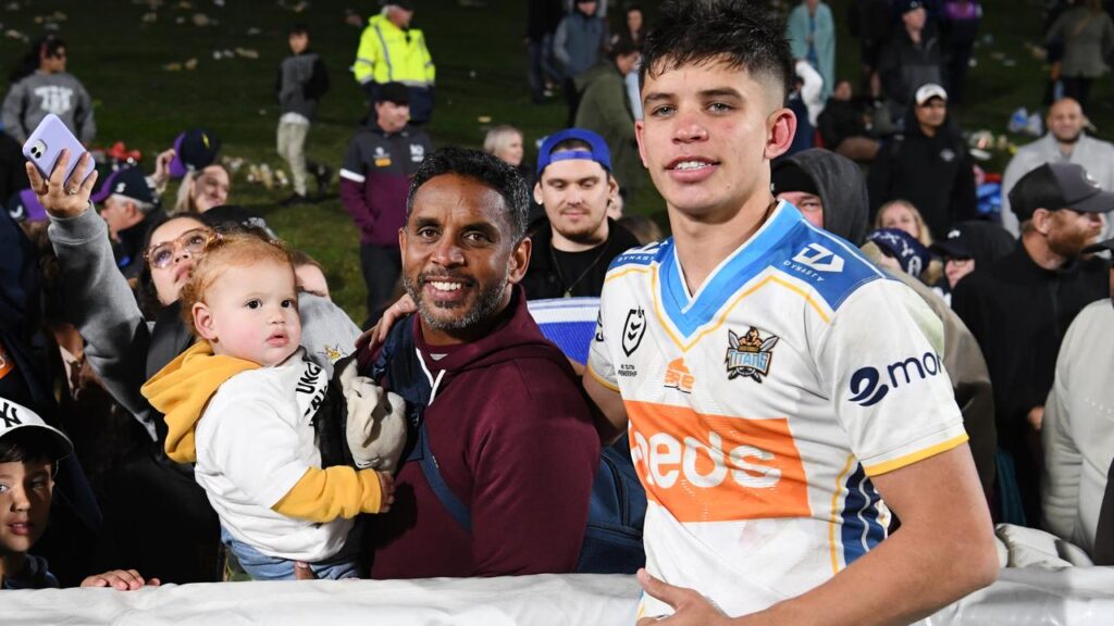Jayden Campbell (r) gets support from father Preston (l) after his Gold Coast debut in 2021.
