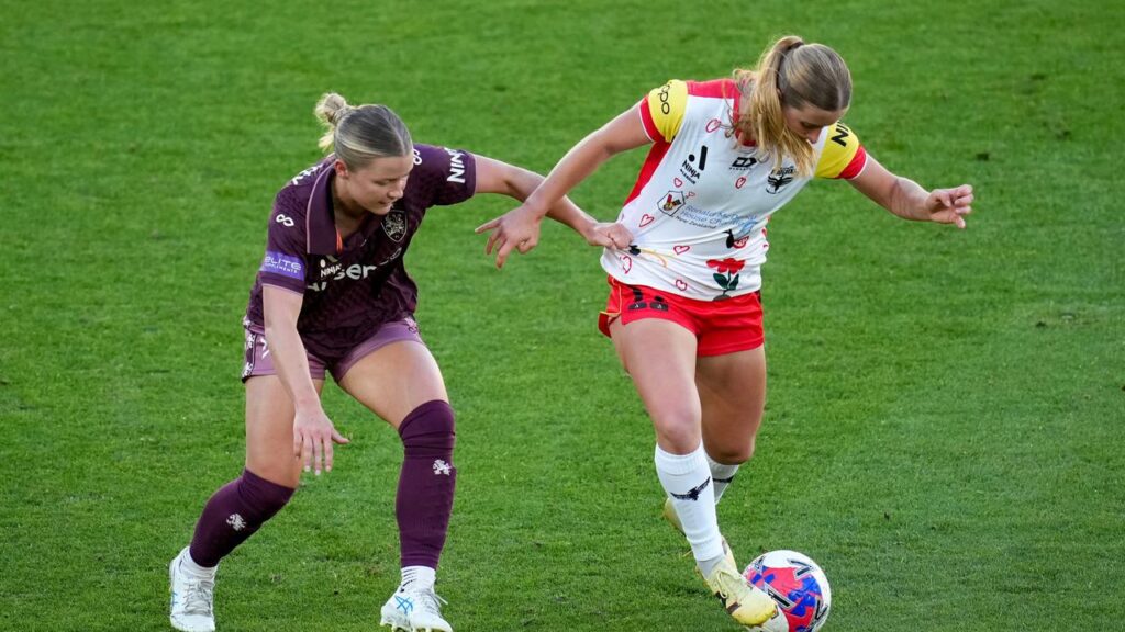 Phoenix goalscorer Manaia Elliott (right) tries to fend off Brisbane’s Aimee Medwin in Wellington.
