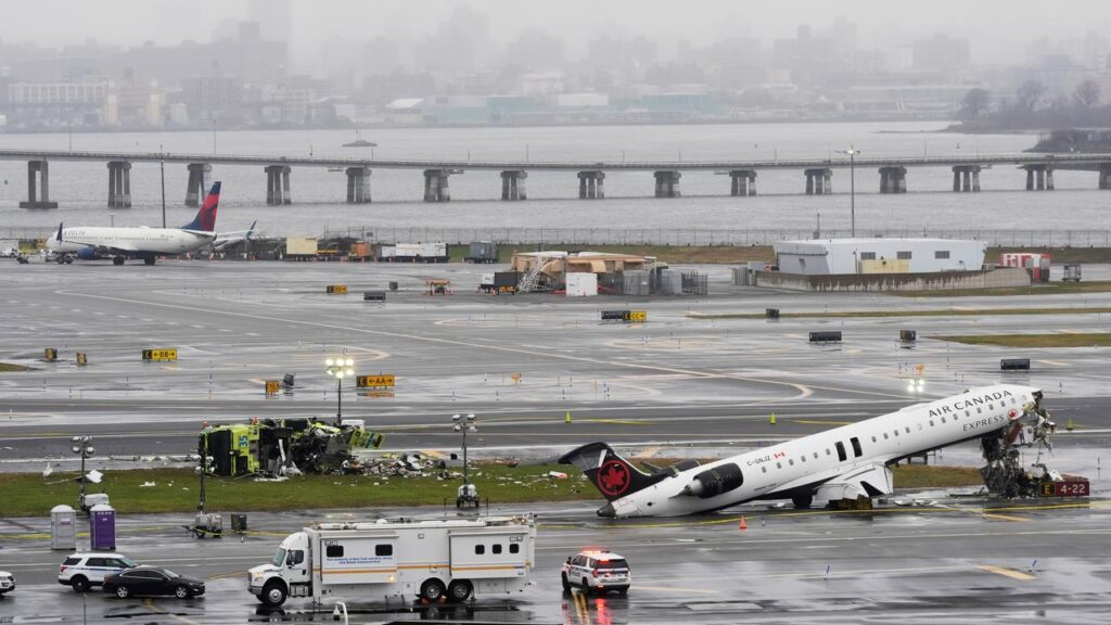 An Air Canada jet and a fire truck at New York’s LaGuardia Airport after the deadly collision.
